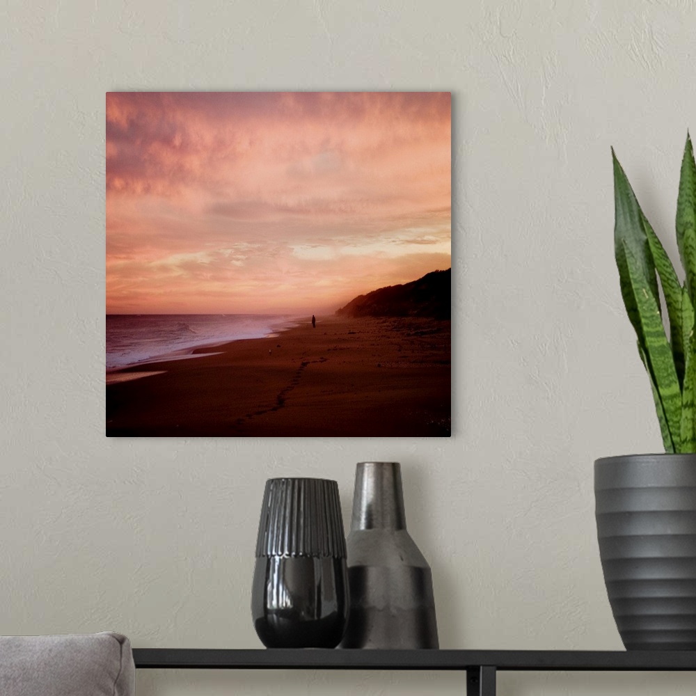 A modern room featuring The Australian coast at sunset with a figure in the distance