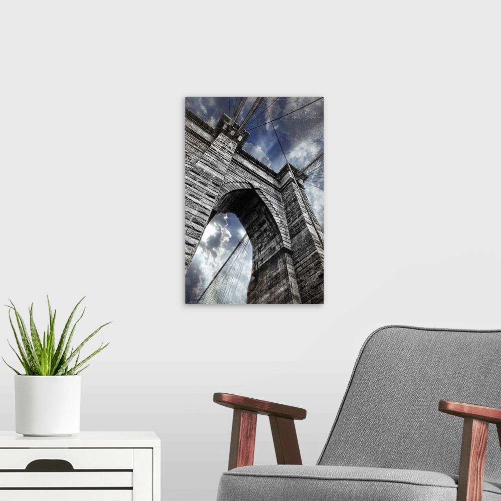 A modern room featuring This large vertical piece is a photograph taken on the Brooklyn bridge and looking up toward the ...