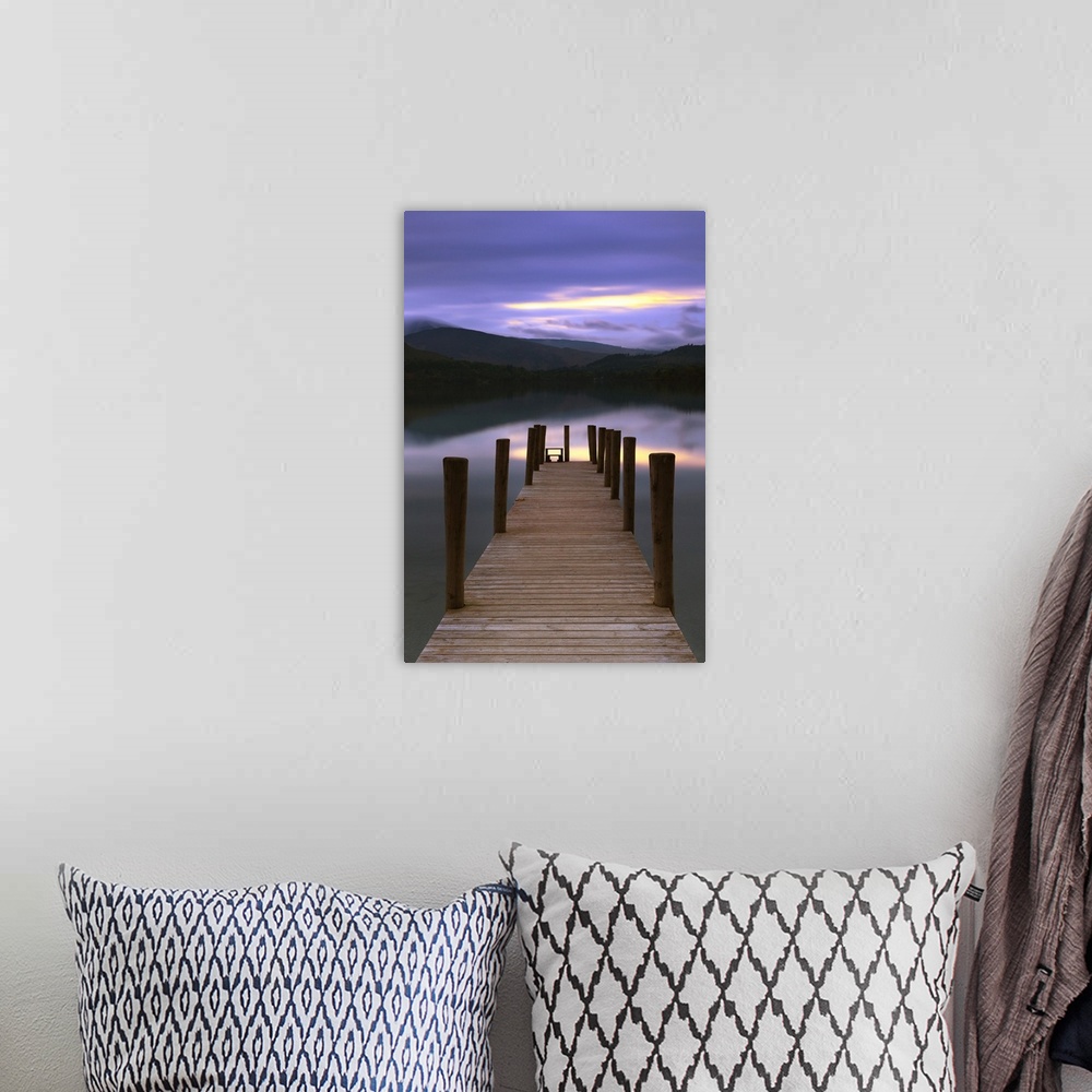 A bohemian room featuring Jetty at twilight in the Lake District with calm water under a sunset