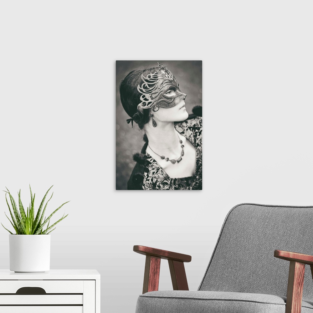 A modern room featuring Profile of victorian girl wearing carnival mask, looking down with sad emotion. Monochrome shot.