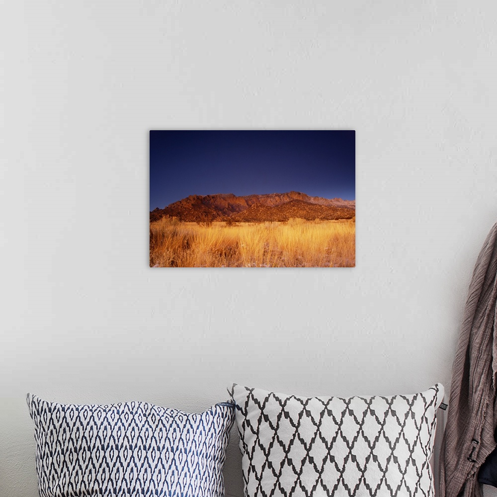A bohemian room featuring travel destinations: the sandia mountains desert twilight landscape glows, albuquerque, new mexico