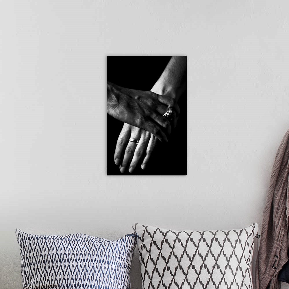 A bohemian room featuring Two women's hands, over a black background
