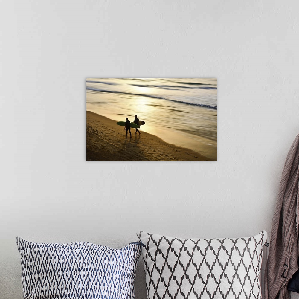 A bohemian room featuring Conceptual beach scene with two figures carrying surf boards