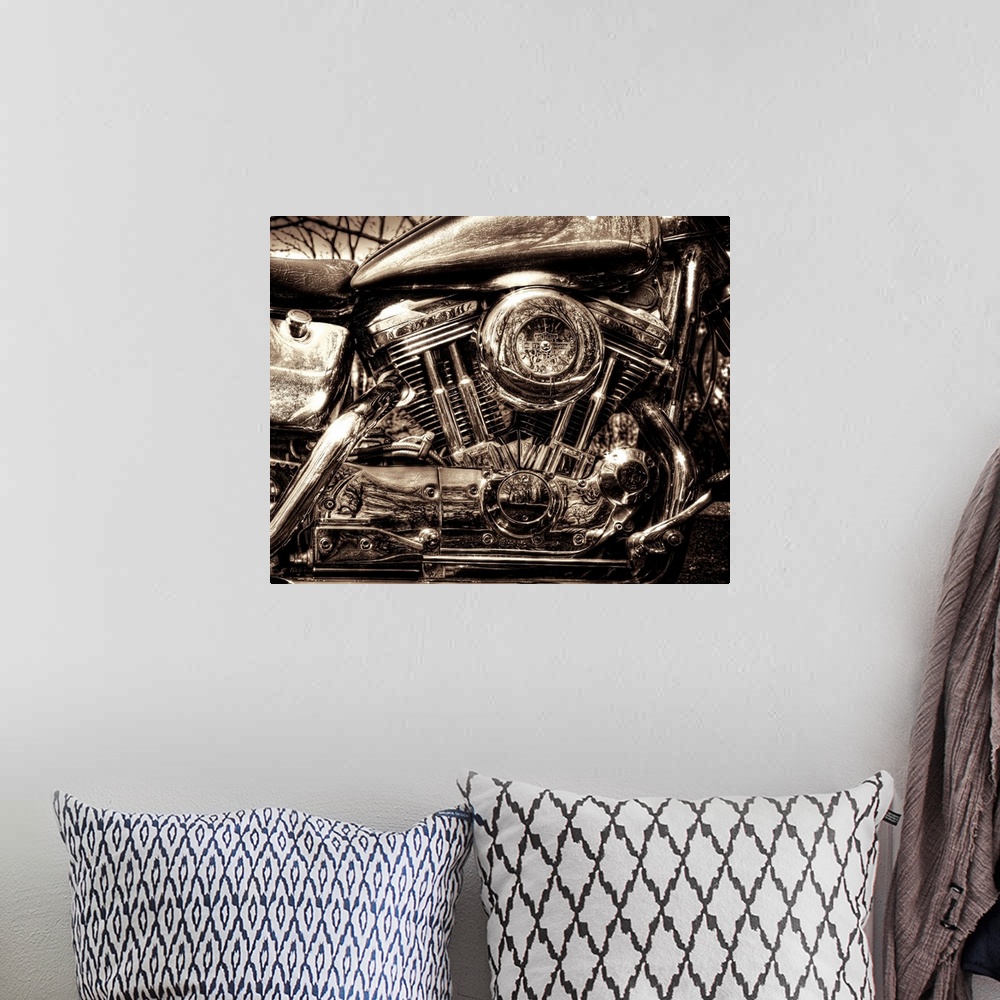 A bohemian room featuring Up-close photograph of engine of Harley Davidson motorcycle.