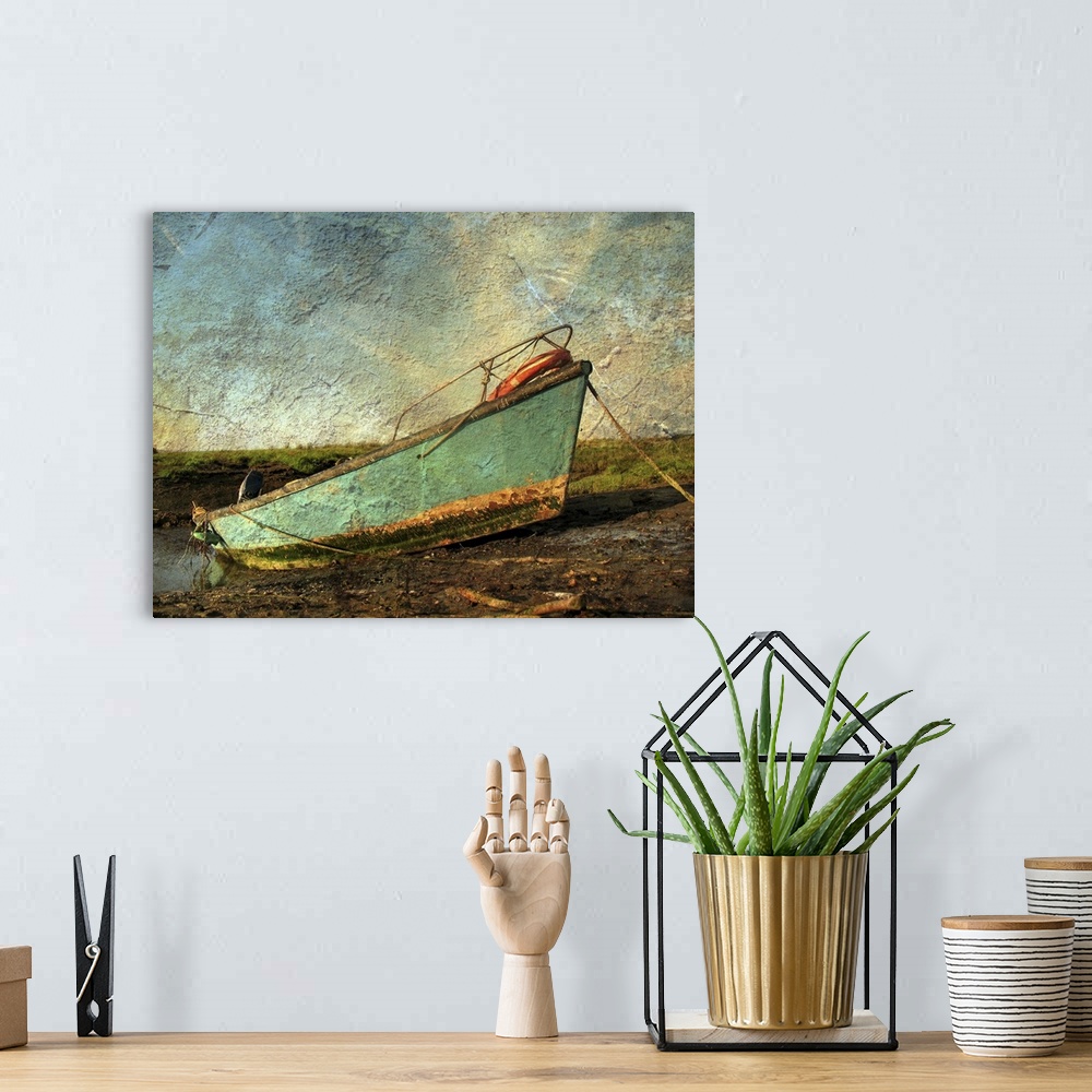 A bohemian room featuring A small boat on mud flats with texture