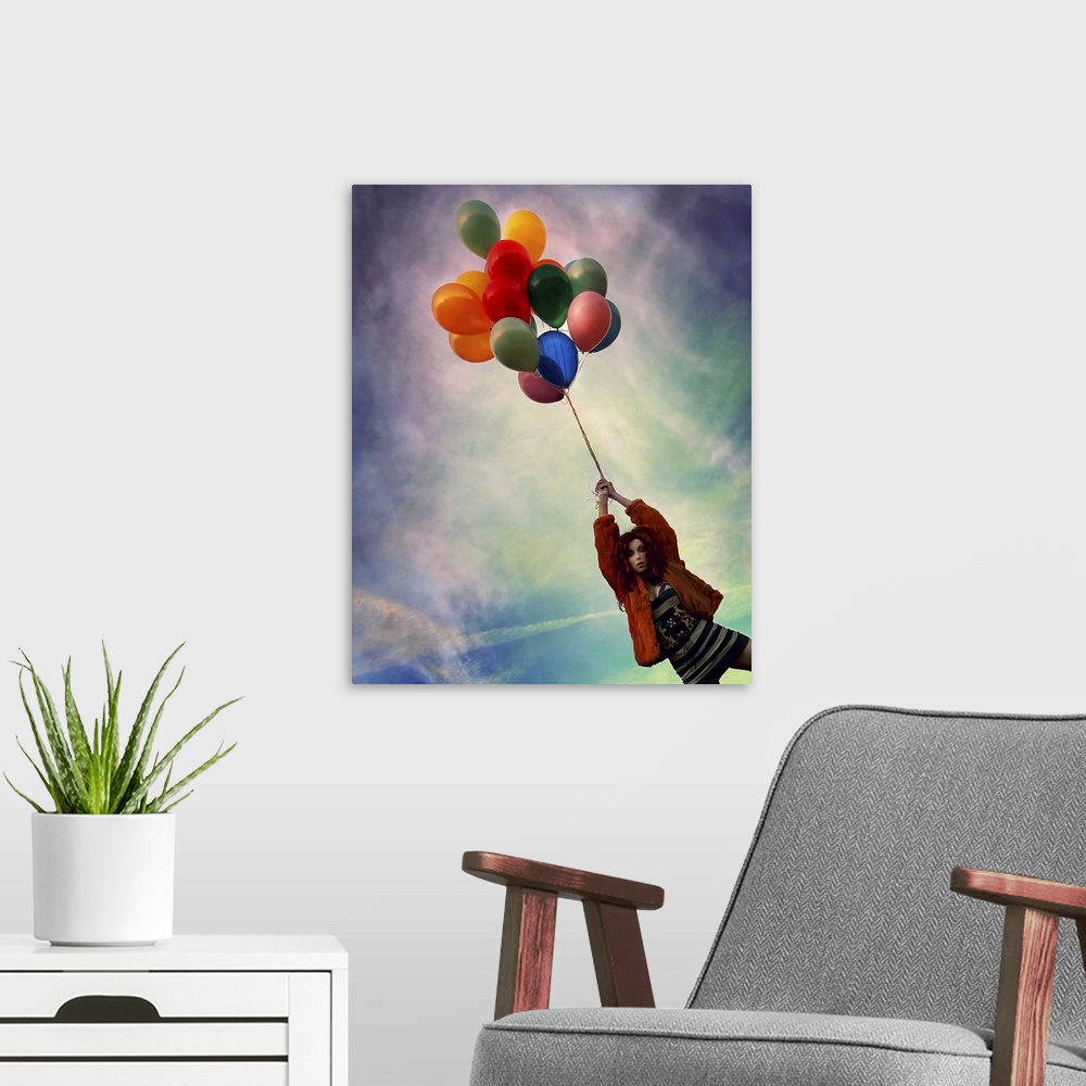 A modern room featuring A young woman holding balloons