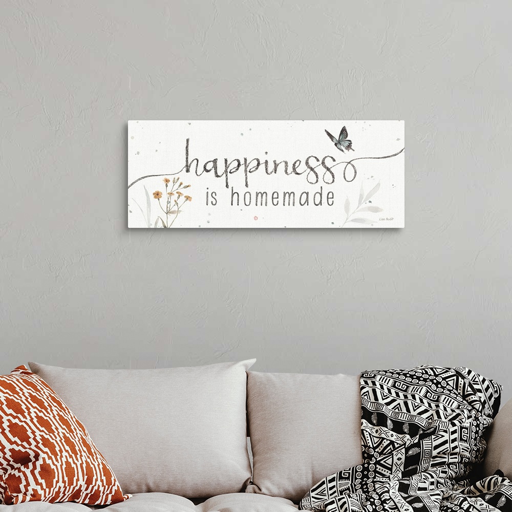 A bohemian room featuring Decorative artwork featuring the words, 'happiness is homemade'.