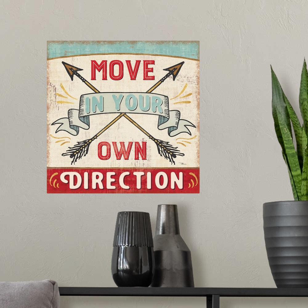A modern room featuring Vintage style sign with crossed arrows reading "Move in your own direction."