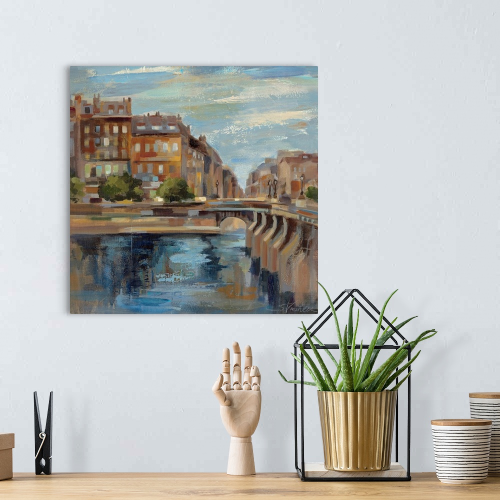 A bohemian room featuring This contemporary artwork is a painting of scenery in Paris with a small bridge over water and bu...
