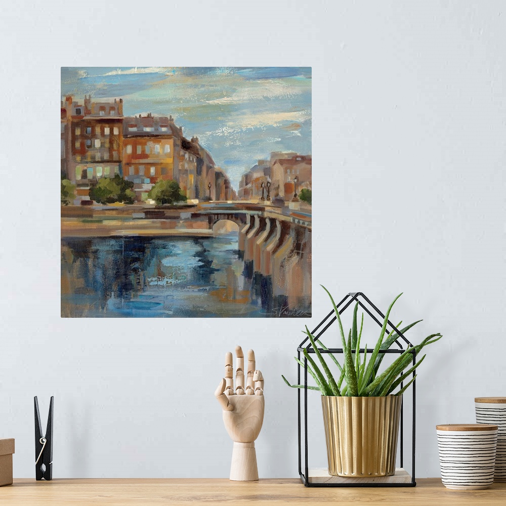 A bohemian room featuring This contemporary artwork is a painting of scenery in Paris with a small bridge over water and bu...