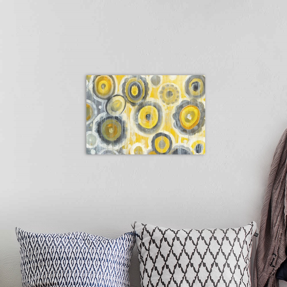 A bohemian room featuring Geometric abstract painting with yellow, gray, and white circles and white paint drips falling fr...