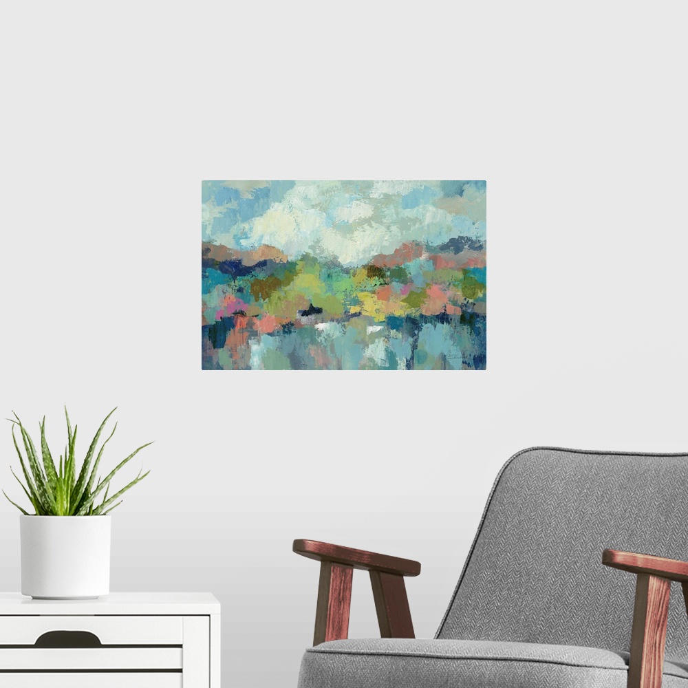 A modern room featuring Contemporary artwork of a blue lake with green hills surrounding it.
