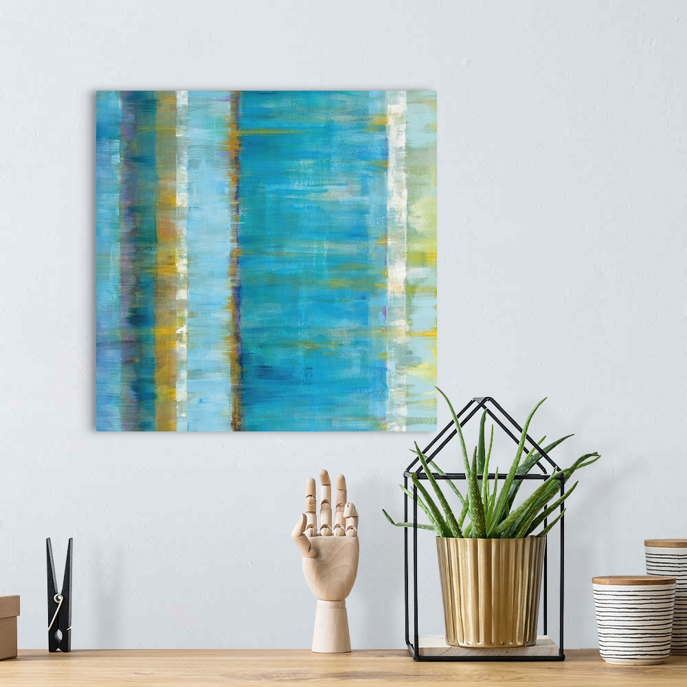 A bohemian room featuring Abstract contemporary artwork in cool blue and golden tones.