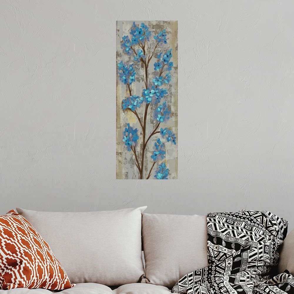 A bohemian room featuring Tall vertical artwork of blue contemporary flowers over distressed background.