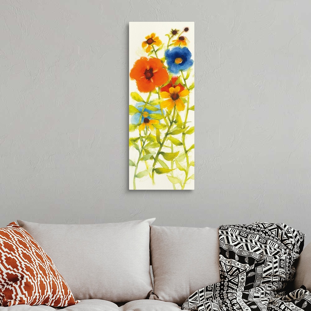 A bohemian room featuring Tall watercolor painting of red, yellow, orange, and blue flowers on a white background.