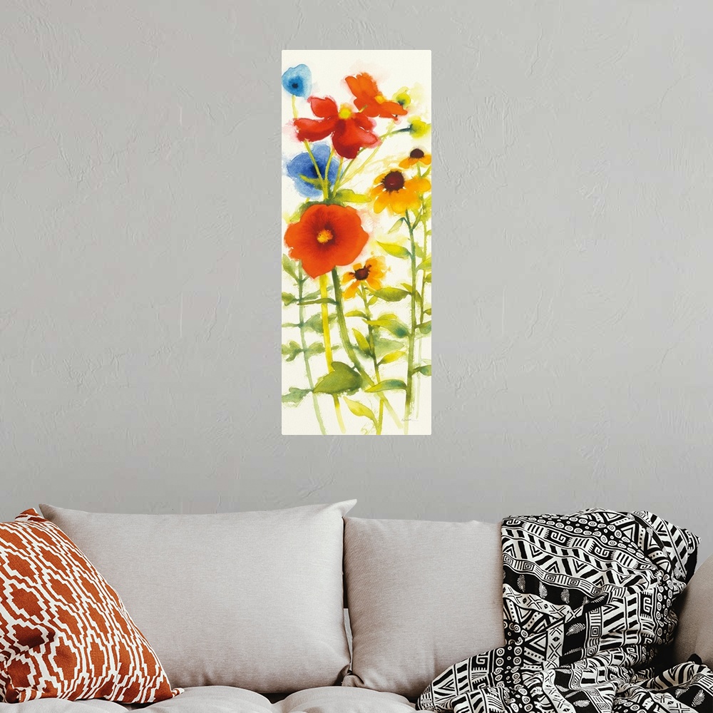A bohemian room featuring Tall watercolor painting of red, yellow, and blue flowers on a white background.