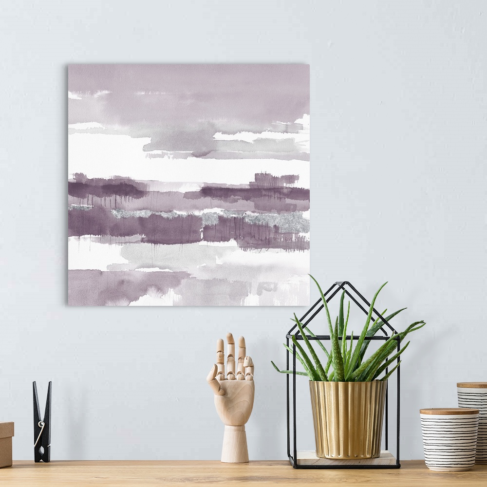 A bohemian room featuring A square watercolor painting of horizontal brush strokes in shades of light purple and grey.