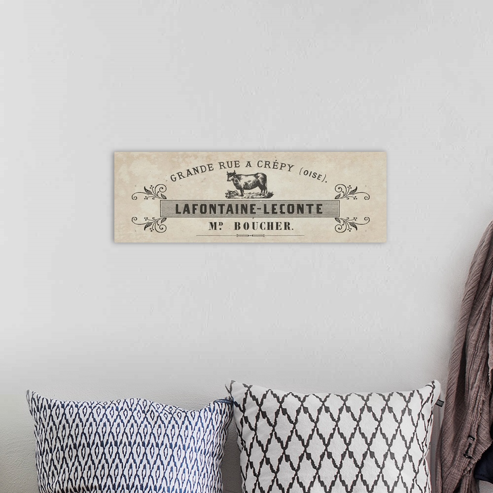 A bohemian room featuring Vintage label for a French butcher shop selling cuts of beef.