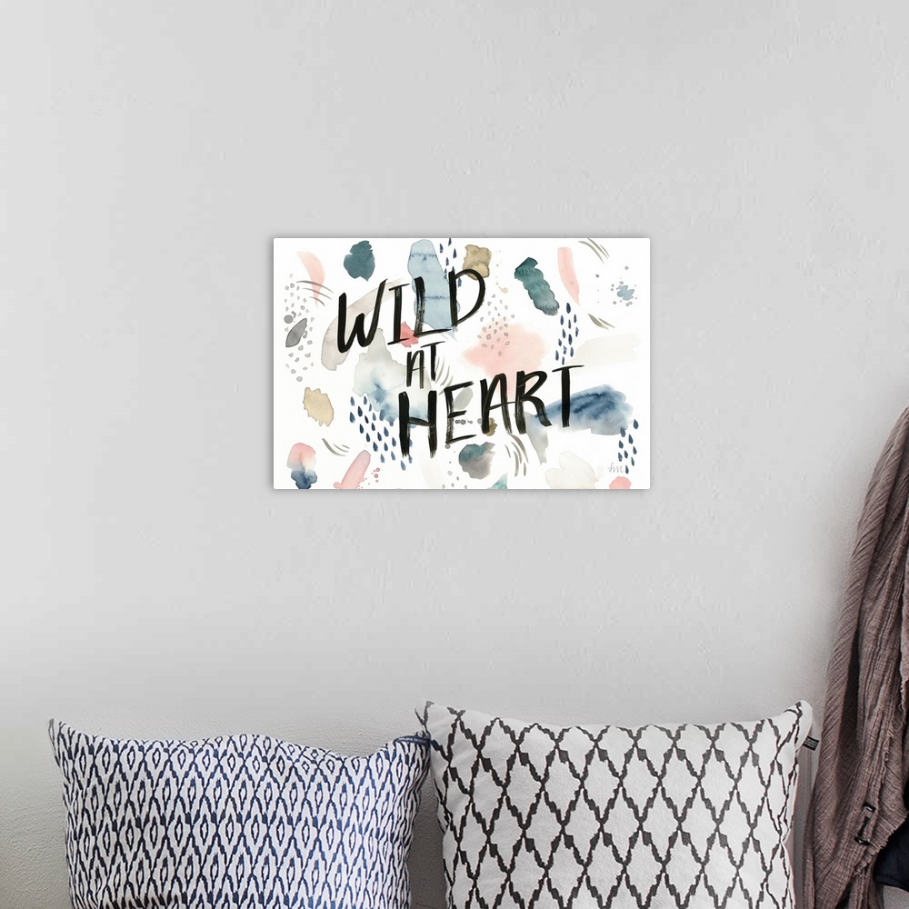 A bohemian room featuring Watercolor boho decor with the phrase "Wild At Heart" written in black on the top.