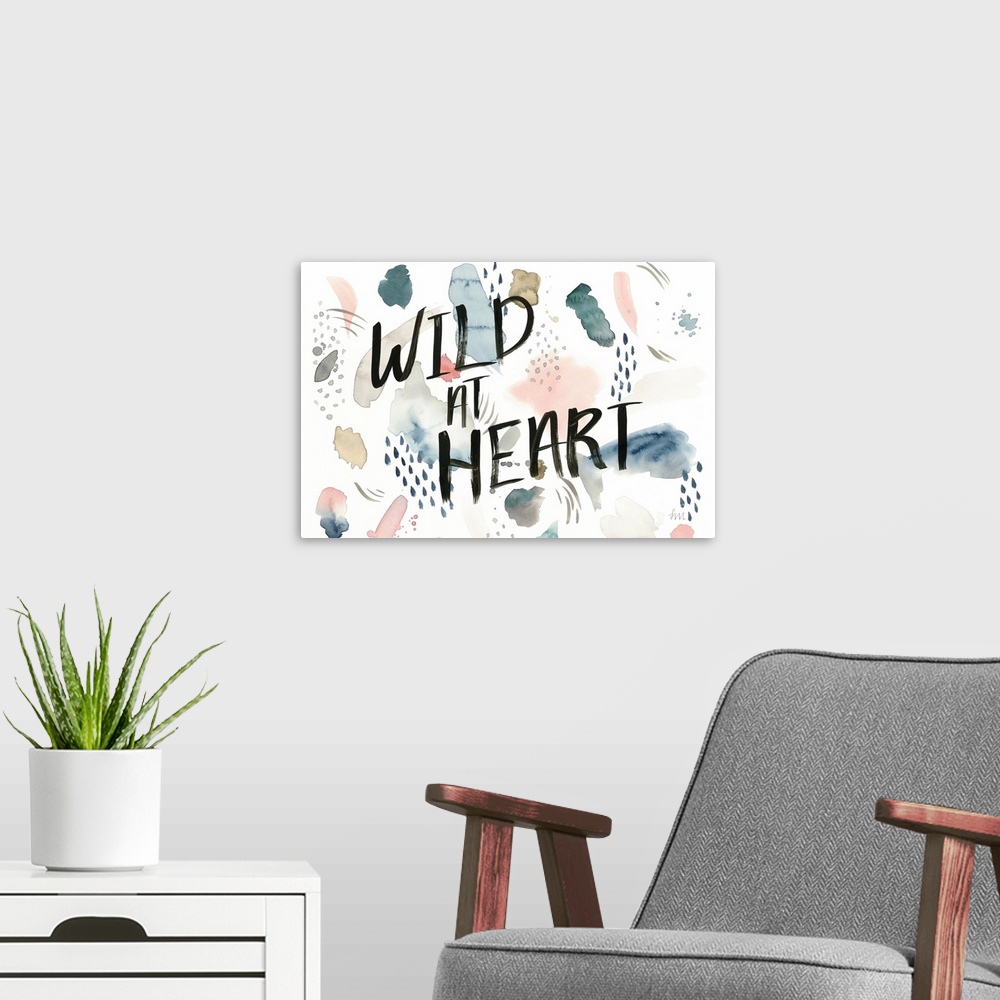 A modern room featuring Watercolor boho decor with the phrase "Wild At Heart" written in black on the top.