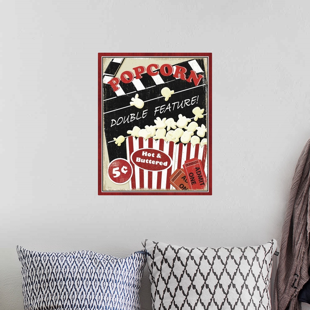 A bohemian room featuring Portrait, vintage artwork on a big wall hanging, advertising popcorn at the movies for five cents...