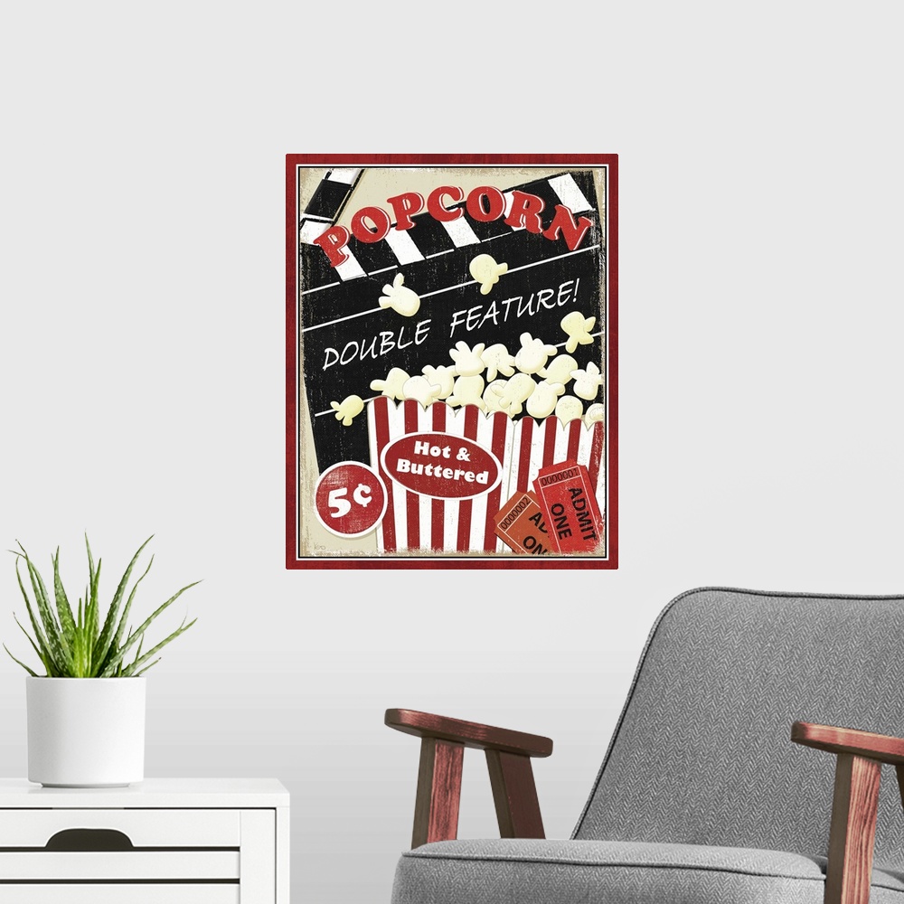 A modern room featuring Portrait, vintage artwork on a big wall hanging, advertising popcorn at the movies for five cents...