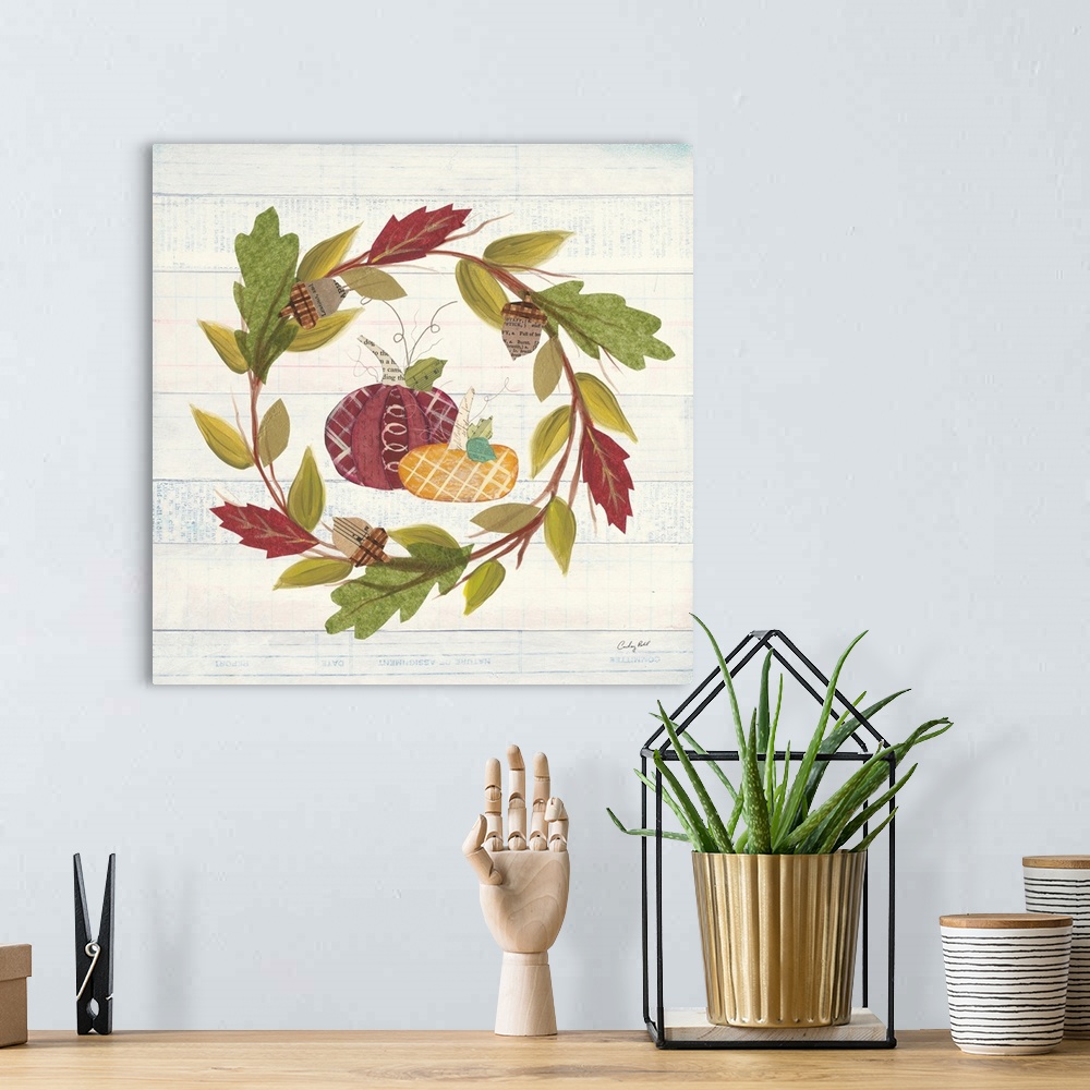 A bohemian room featuring Decorative artwork of a wreath of fall leaves with pumpkins and a white wood background.