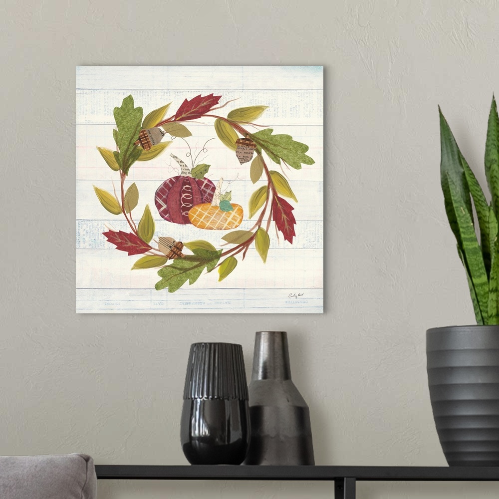 A modern room featuring Decorative artwork of a wreath of fall leaves with pumpkins and a white wood background.