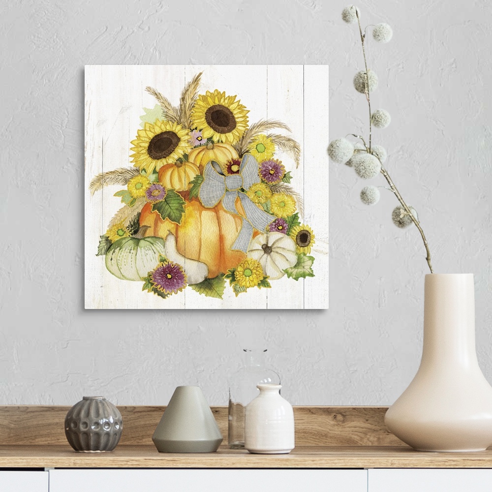 A farmhouse room featuring A square Fall decorative piece with an arrangement of flowers and pumpkins on a white wood panele...