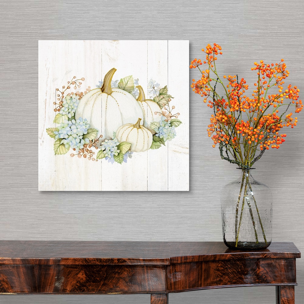 A traditional room featuring A square Fall decorative piece with an arrangement of flowers and pumpkins on a white wood panele...