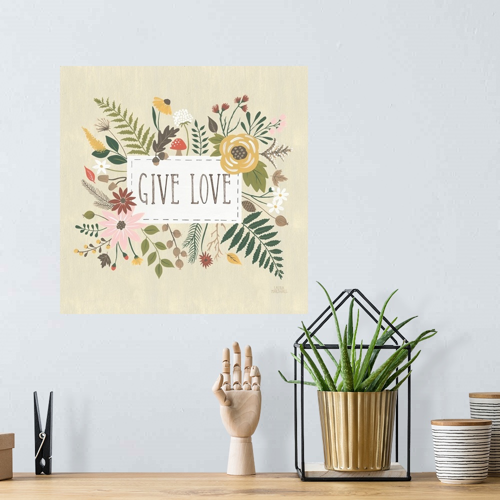 A bohemian room featuring "Give Love" written in a white rectangle on a light tan background, surrounded by Autumn flowers.
