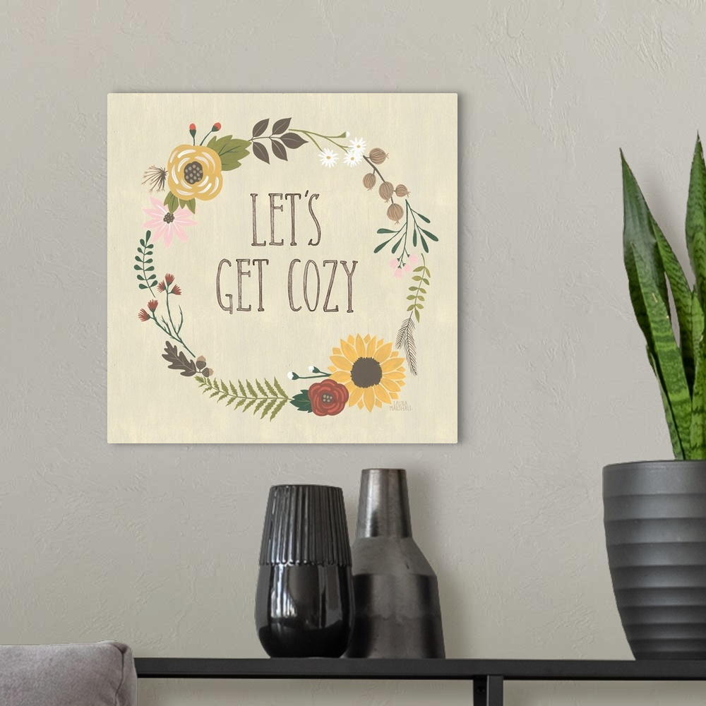 A modern room featuring "Let's Get Cozy" in the center of a wreath of autumn flowers on a beige background.