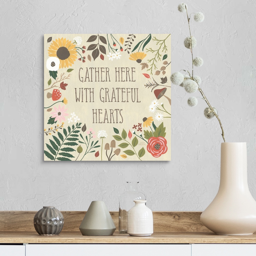 A farmhouse room featuring "Gather here with grateful hearts" written on a tan background and surrounded by Autumn flowers.