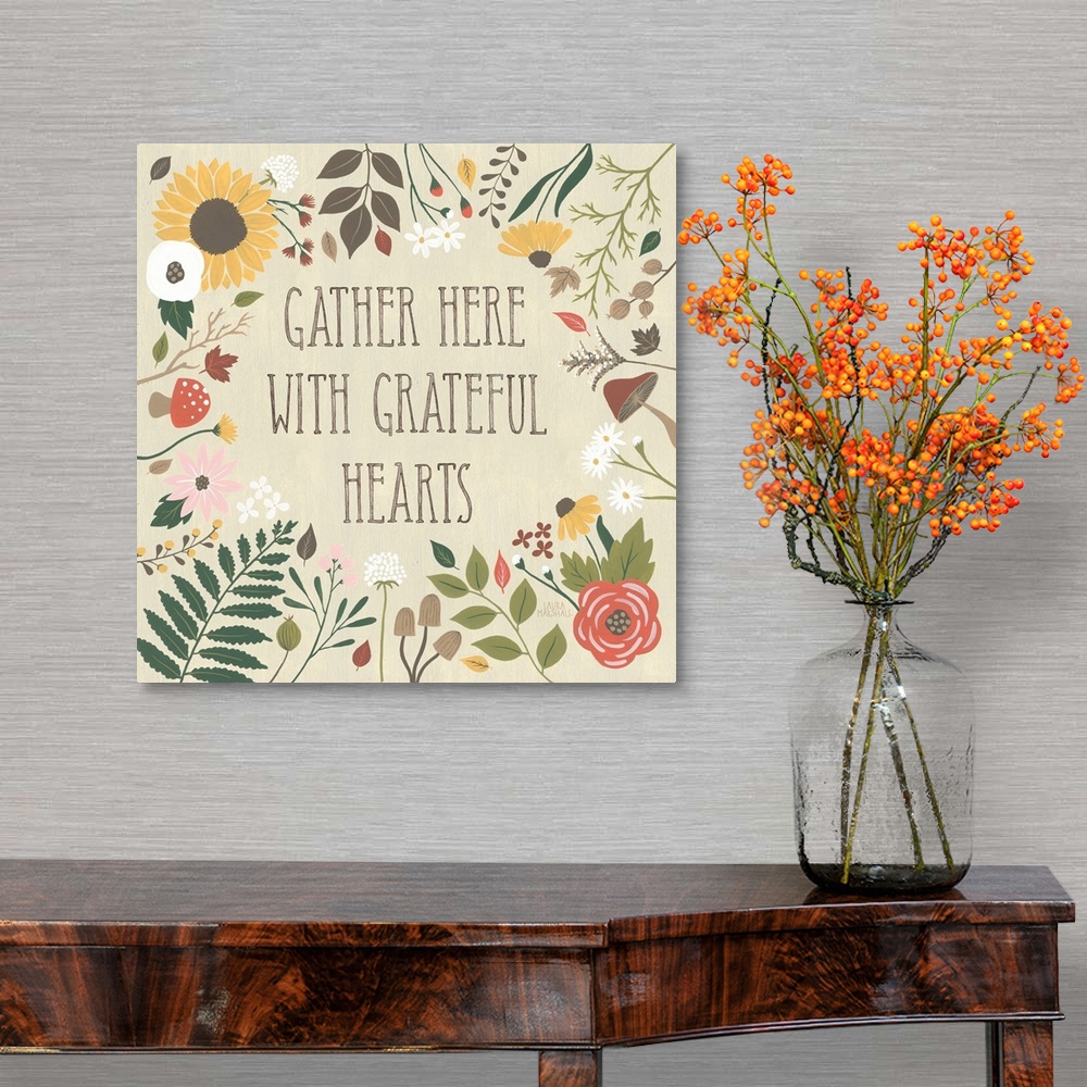 A traditional room featuring "Gather here with grateful hearts" written on a tan background and surrounded by Autumn flowers.