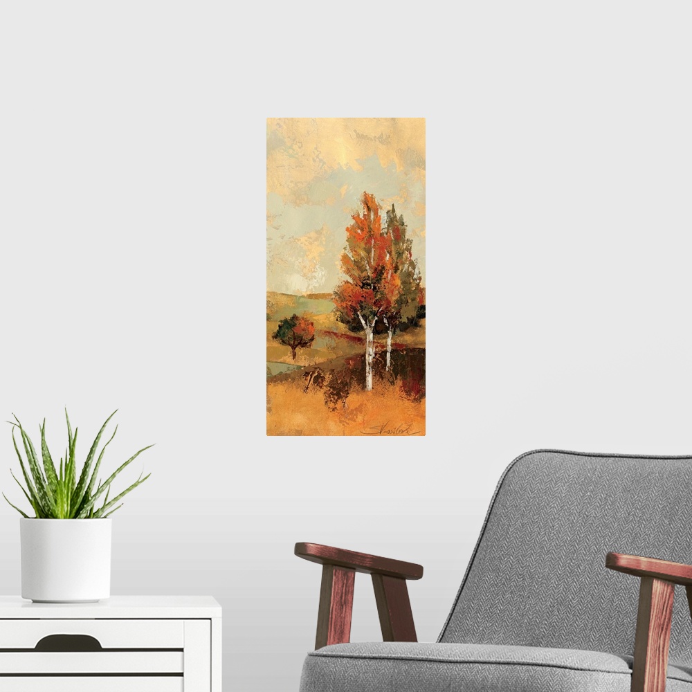 A modern room featuring Portrait, large wall painting of a fall scene of rolling hills and several trees with autumn colo...