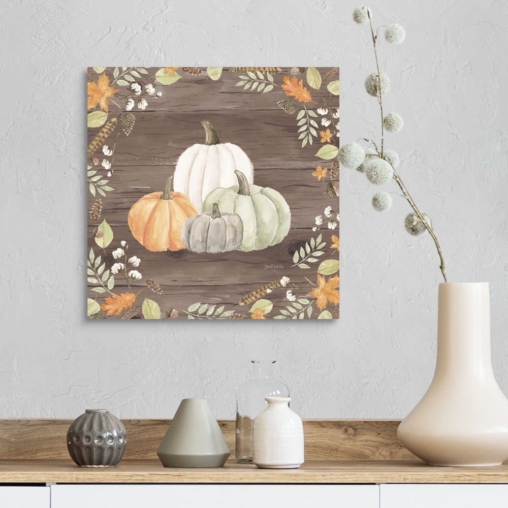 A farmhouse room featuring Decorative artwork of fall leaves framing a group of pumpkins and a brown wood background.