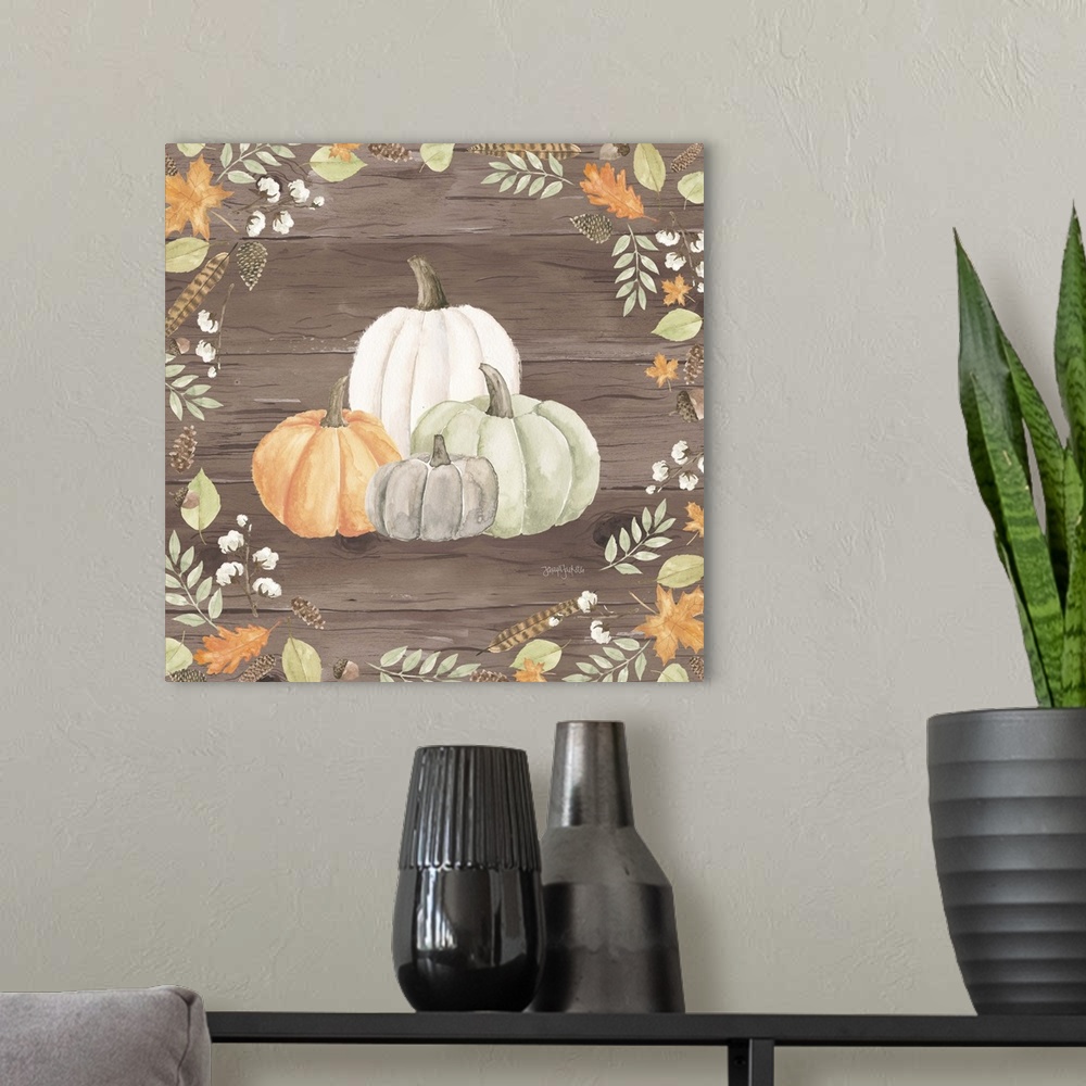 A modern room featuring Decorative artwork of fall leaves framing a group of pumpkins and a brown wood background.