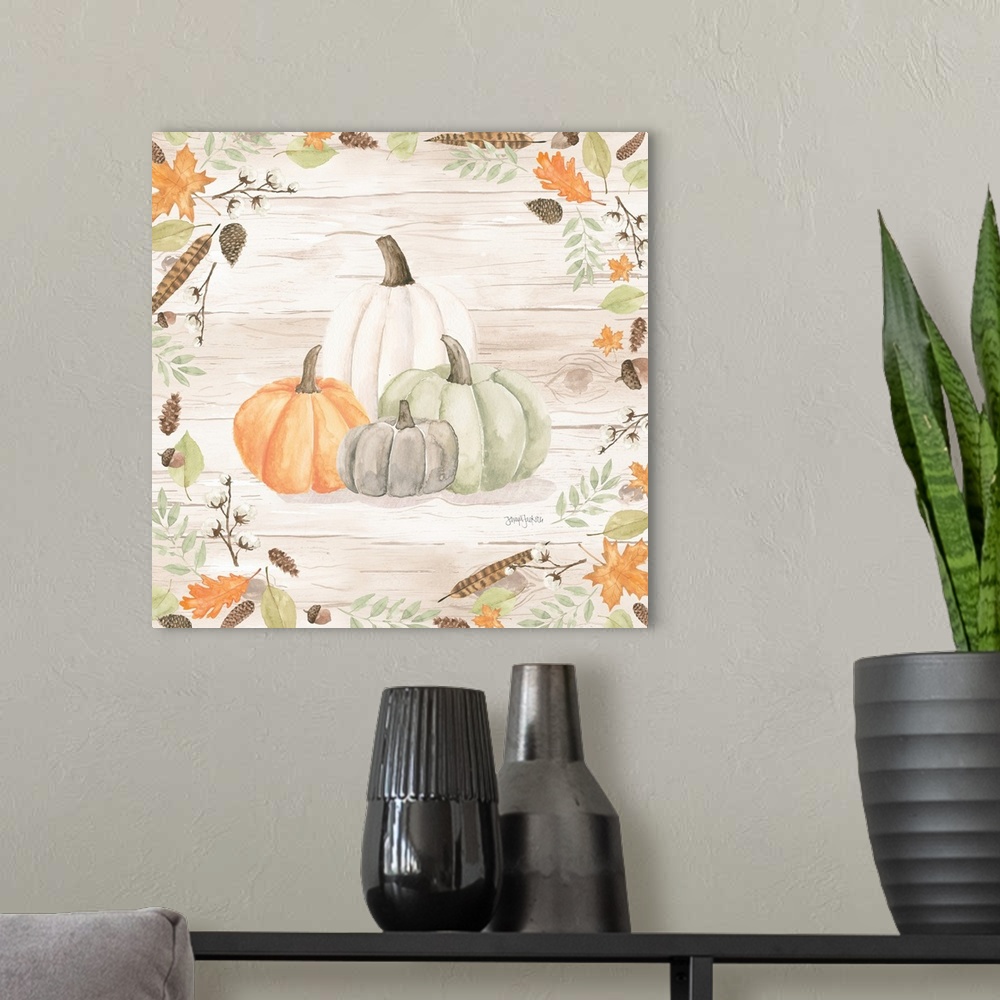 A modern room featuring Decorative artwork of fall leaves framing a group of pumpkins and a white wood background.