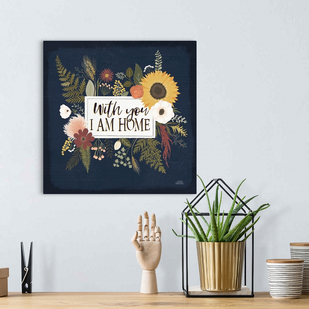 A bohemian room featuring Decorative floral artwork featuring autumn colors and the words, 'With you, I am home'.
