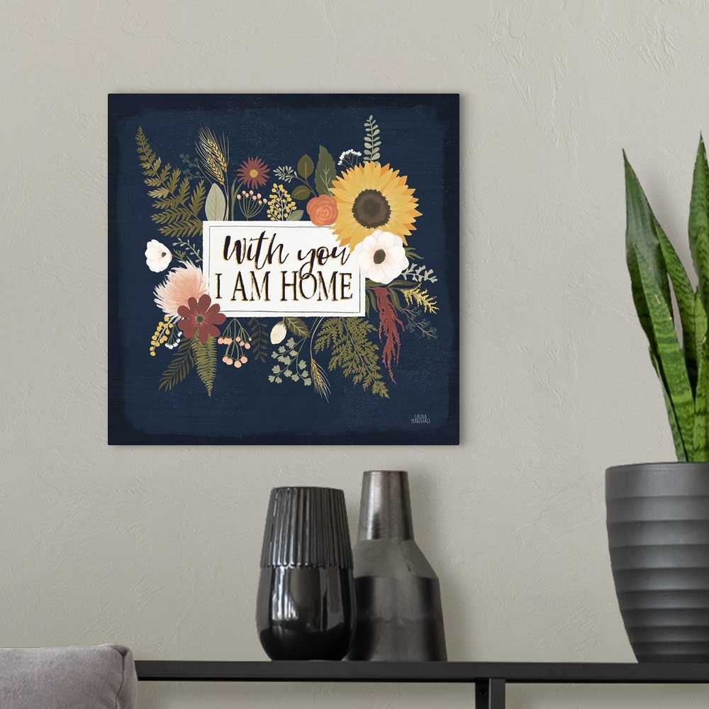 A modern room featuring Decorative floral artwork featuring autumn colors and the words, 'With you, I am home'.