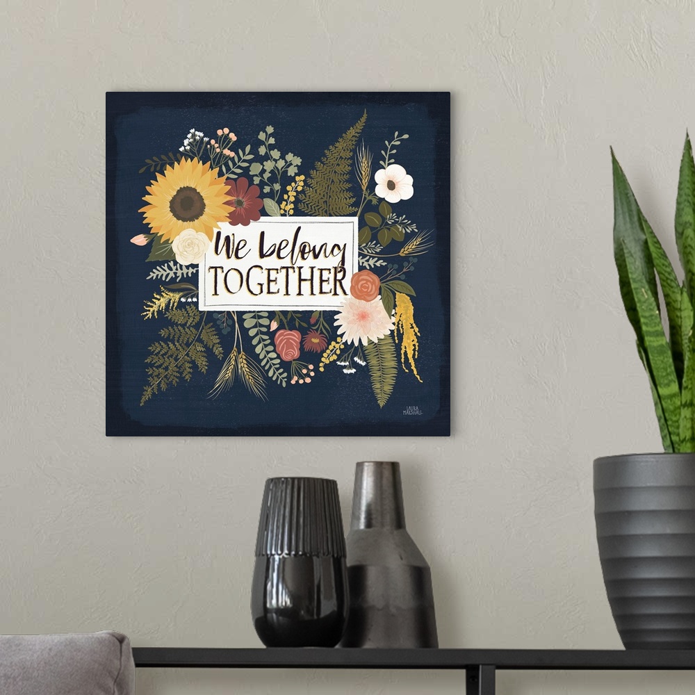 A modern room featuring Decorative floral artwork featuring autumn colors and the words, 'We belong together'.