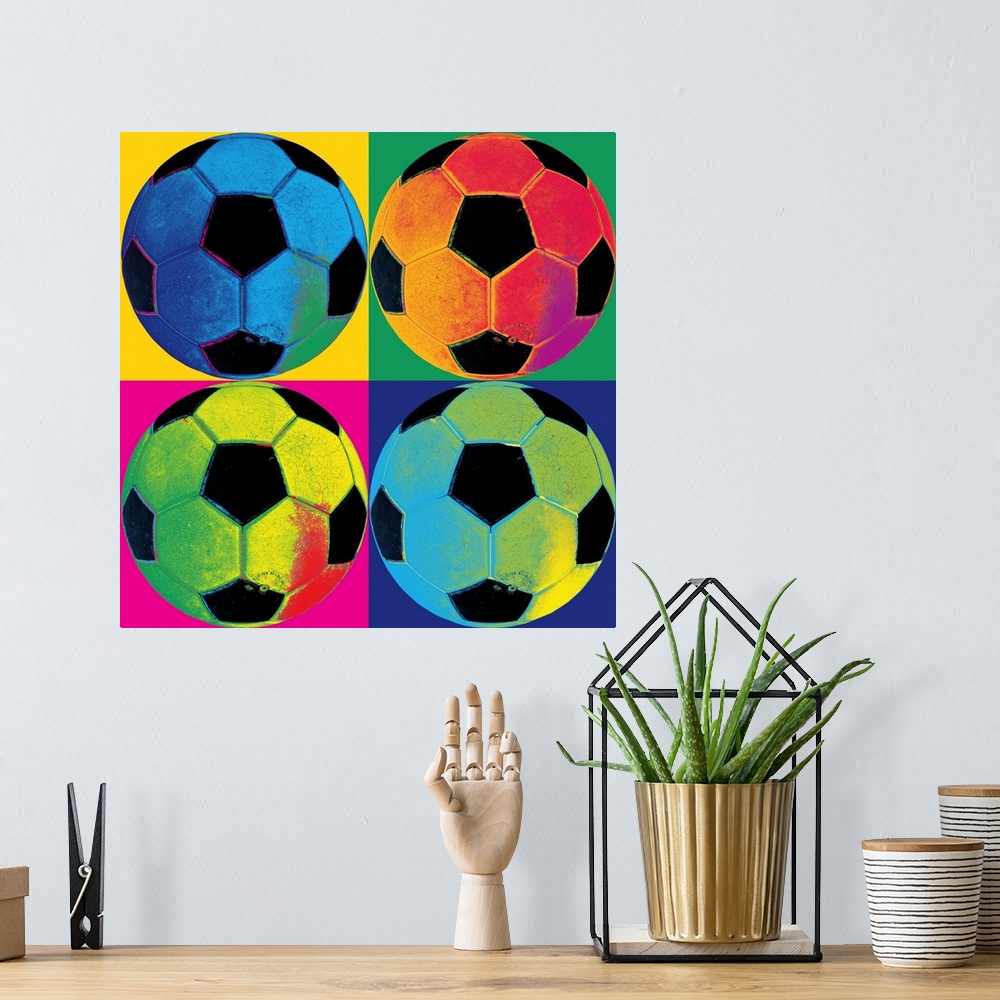 A bohemian room featuring A square canvas of soccer balls of various neon colors in each of the four quadrants with a diffe...