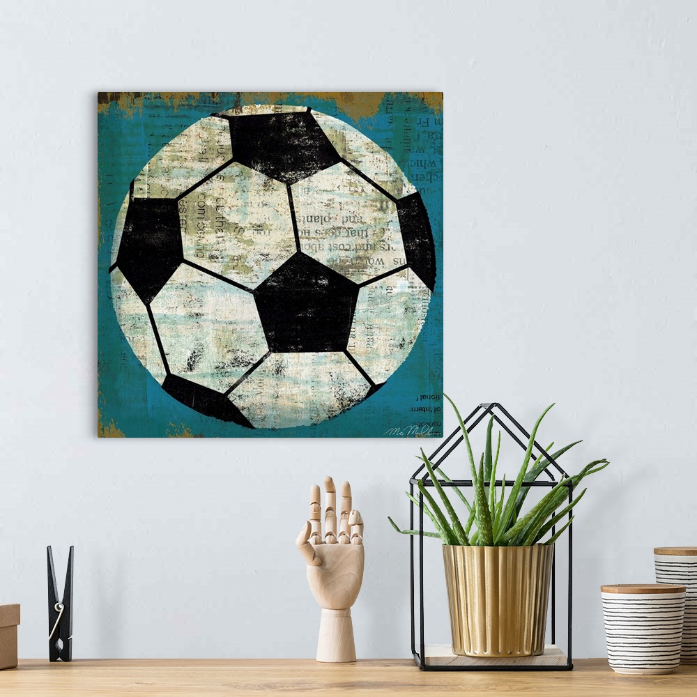 A bohemian room featuring Large retro art depicts a soccer ball incorporating various lines of text within the blank spaces...