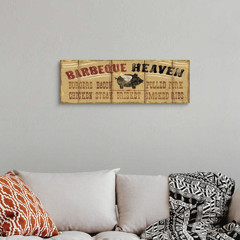 A bohemian room featuring Long horizontal image on canvas of a painting of a pig with wings with the text "Barbeque Heaven".