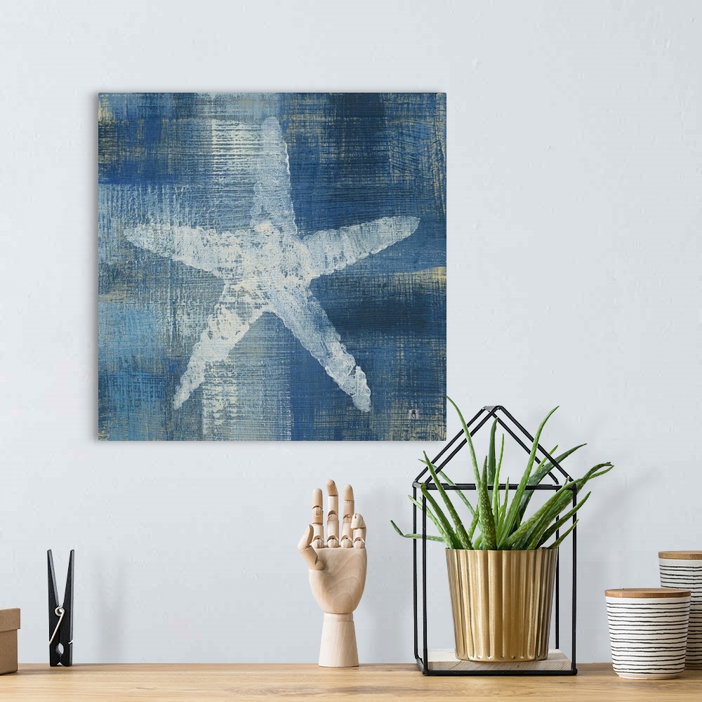 A bohemian room featuring Square artwork of a white starfish among a white and blue brushed finish.