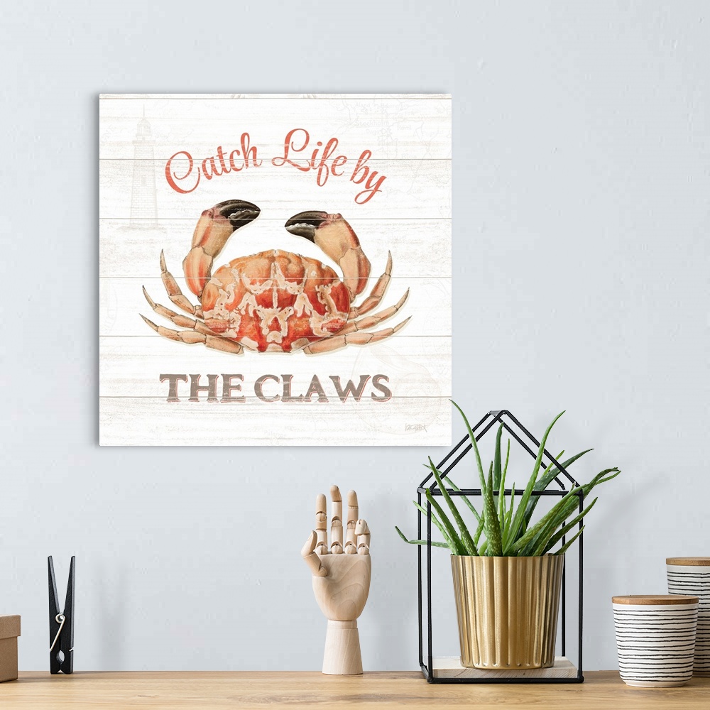 A bohemian room featuring Square beach decor with "Catch Life by The Claws" written around an illustration of a crab, on a ...
