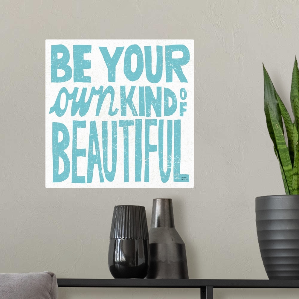 A modern room featuring Inspirational phrase in light blue in hand-written block letters.