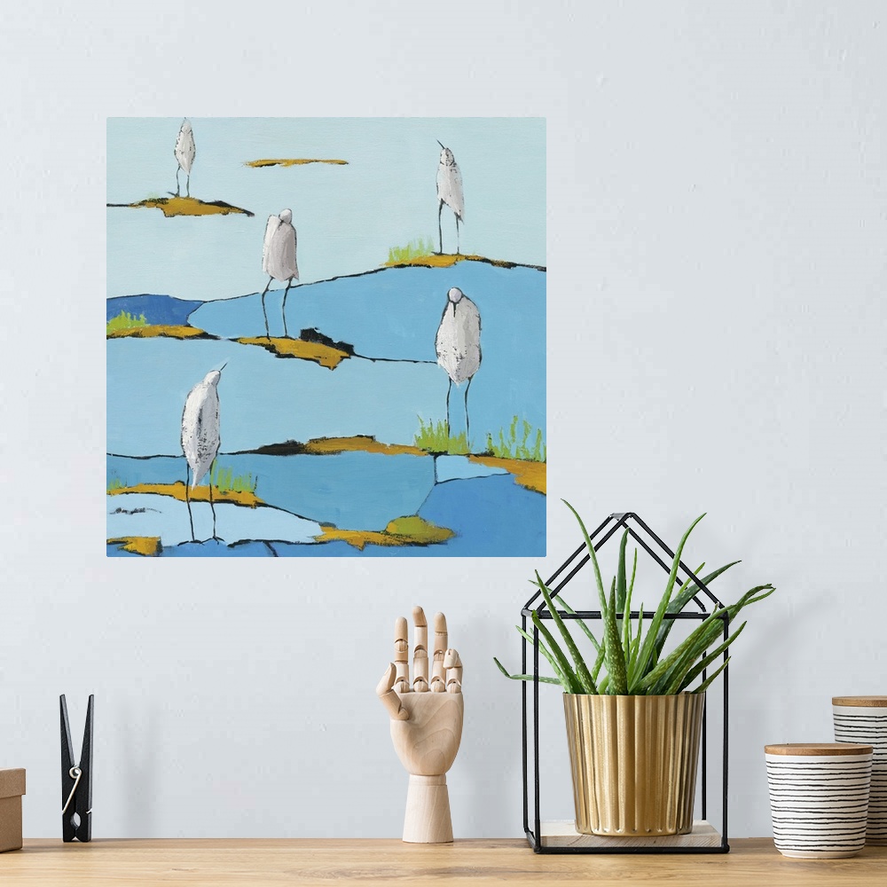 A bohemian room featuring Square abstract painting of five white egrets relaxing on a blue and gold patterned marsh.