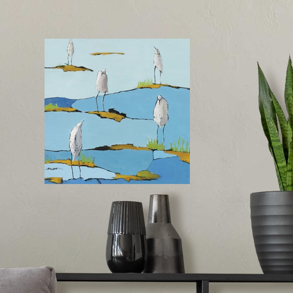 A modern room featuring Square abstract painting of five white egrets relaxing on a blue and gold patterned marsh.
