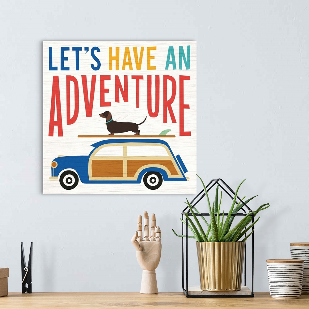 A bohemian room featuring "LET'S HAVE AN ADVENTURE" illustration of a dachshund on top of a surf board on top of a wagon, h...
